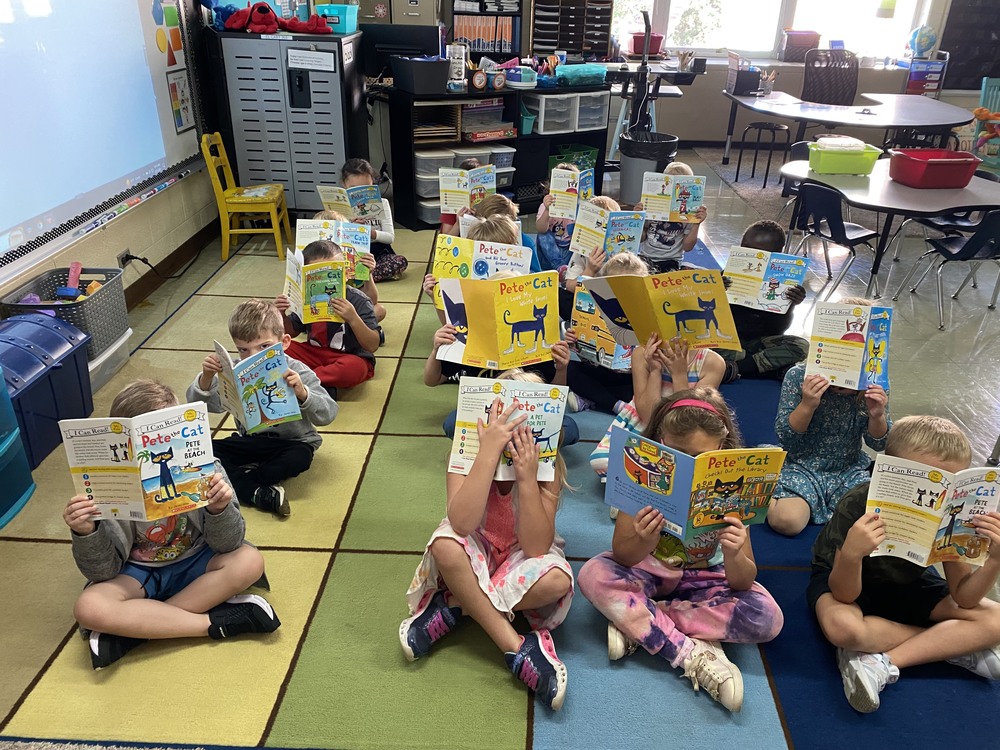 Students sitting in the classroom on the run reading Pete the Cat books