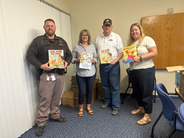 Photo of GPS School Resource Office, GPS Staff with Toys for Tots who delivered free books to Gobles Elementary School