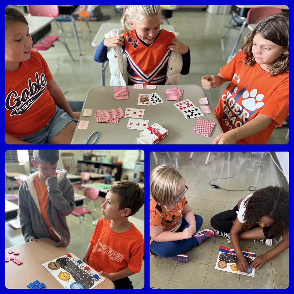 3rd grade students sitting at their desks and on the floor playing cards and a math game for the Bridges curriculum adopted at Gobles Elementary