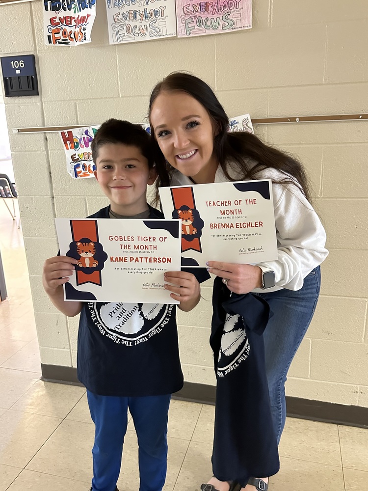 teacher and student receiving Tiger Way award for the month of May