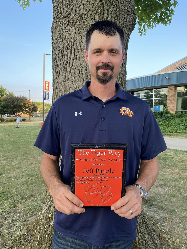 Picture of Jeff Pangle holding plaque for The Tiger Way School Service Award